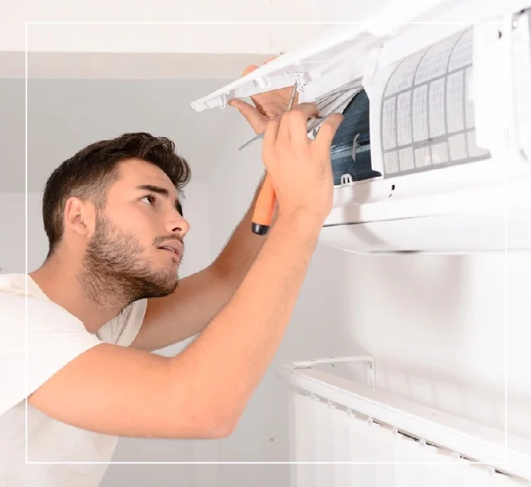 A man is fixing the air conditioner