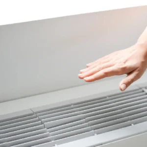 A person is reaching for the air vent.