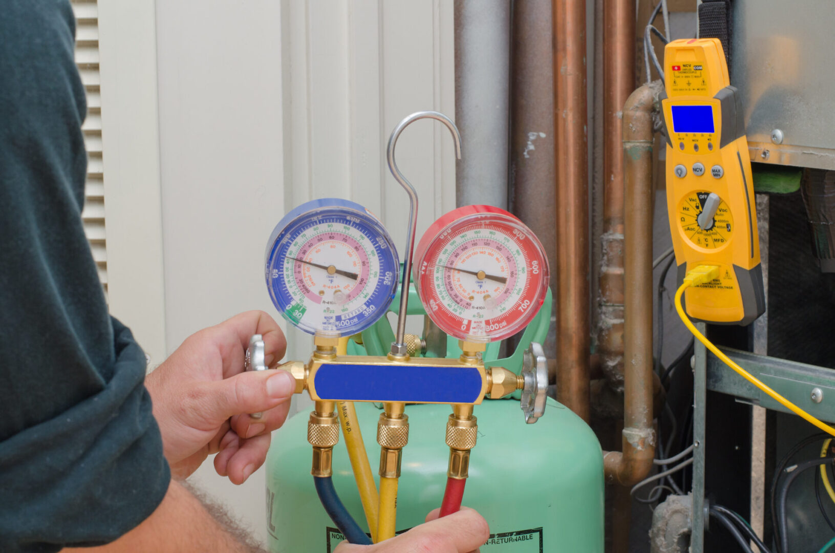 A person is working on an air conditioning unit.